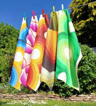 Load image into Gallery viewer, Washing line of retro 70s tea towels in pink, orange, blue green and yellow

