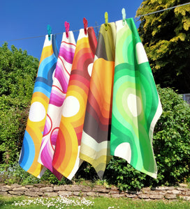Washing line of retro 70s tea towels in pink, orange, blue green and yellow